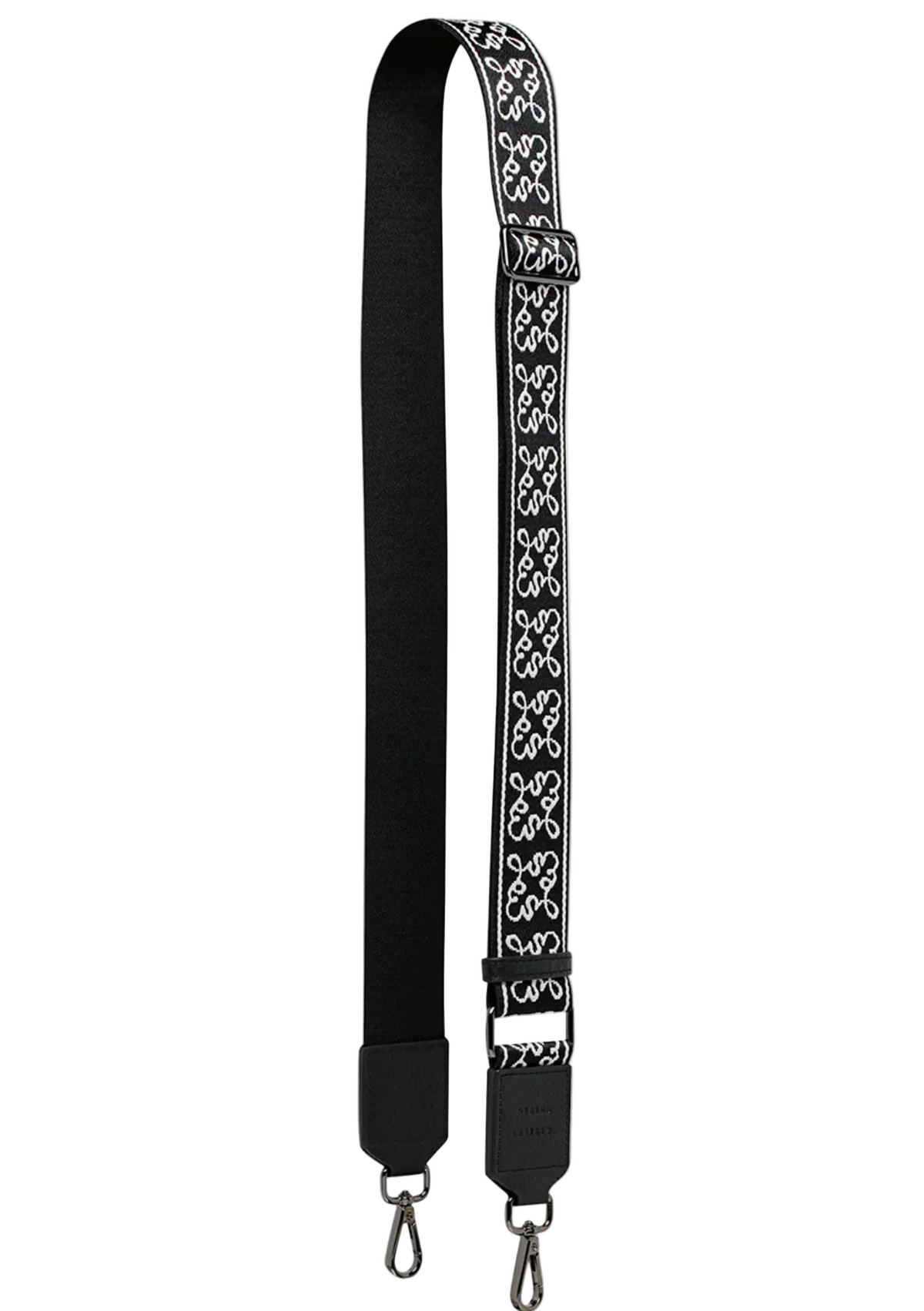 Black bag strap with white floral pattern on a white background